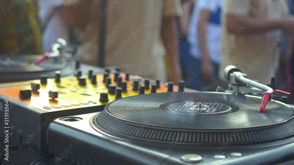 close up person playing music on a turntable, vinyl records close up person playing music on a turntable, vinyl records