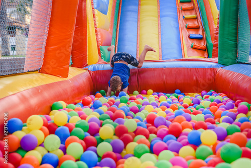 Fotografija Inflatable castle full of colored balls for children to jump