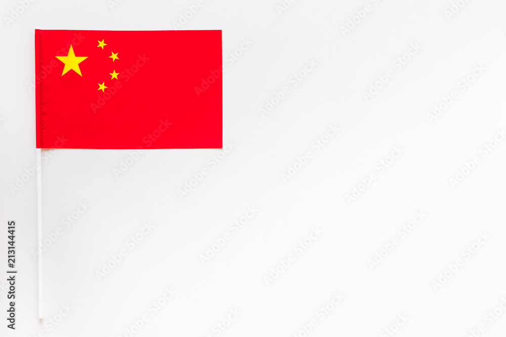 Chinese flag concept. small flag on white background top view copy space Chinese flag concept. small flag on white background top view copy space