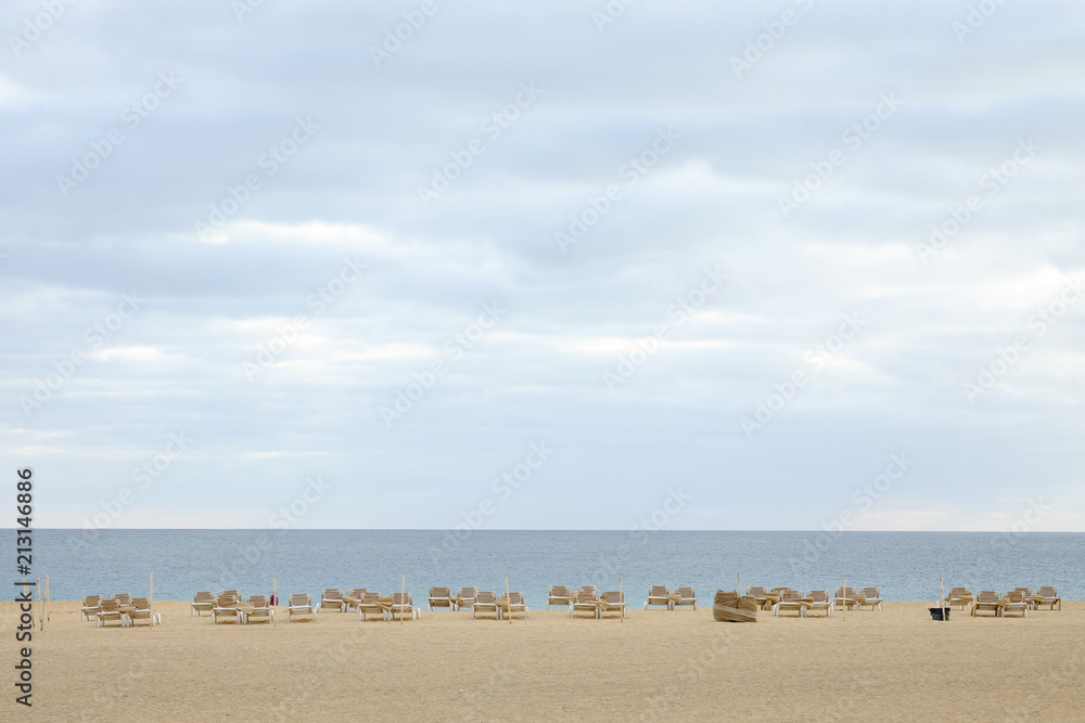 Naklejka premium Beach with white sand and sunbeds and view on the sea