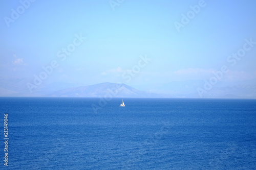 Blue sea and white Boat - view from island Corfu Greece