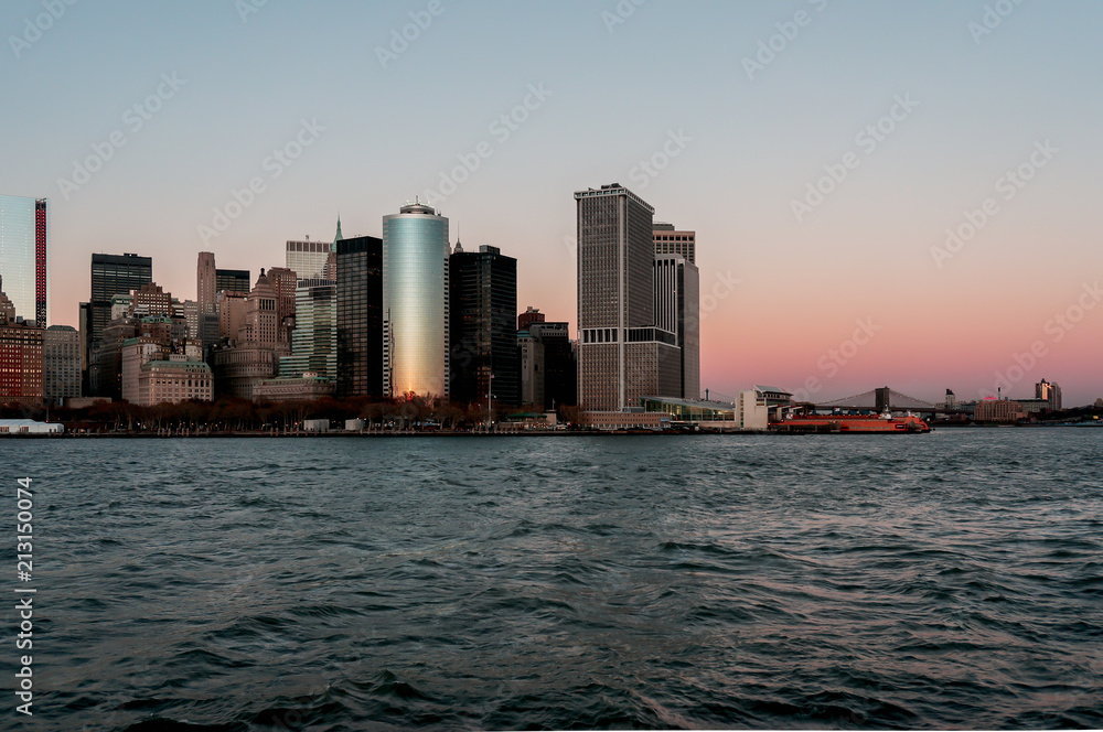New York city skyline sunset view from the boat to Ellis Island New York city skyline sunset view from the boat to Ellis Island
