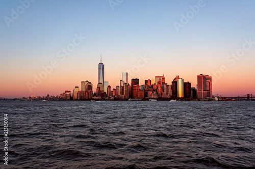 New York city skyline sunset view from the boat to Ellis Island