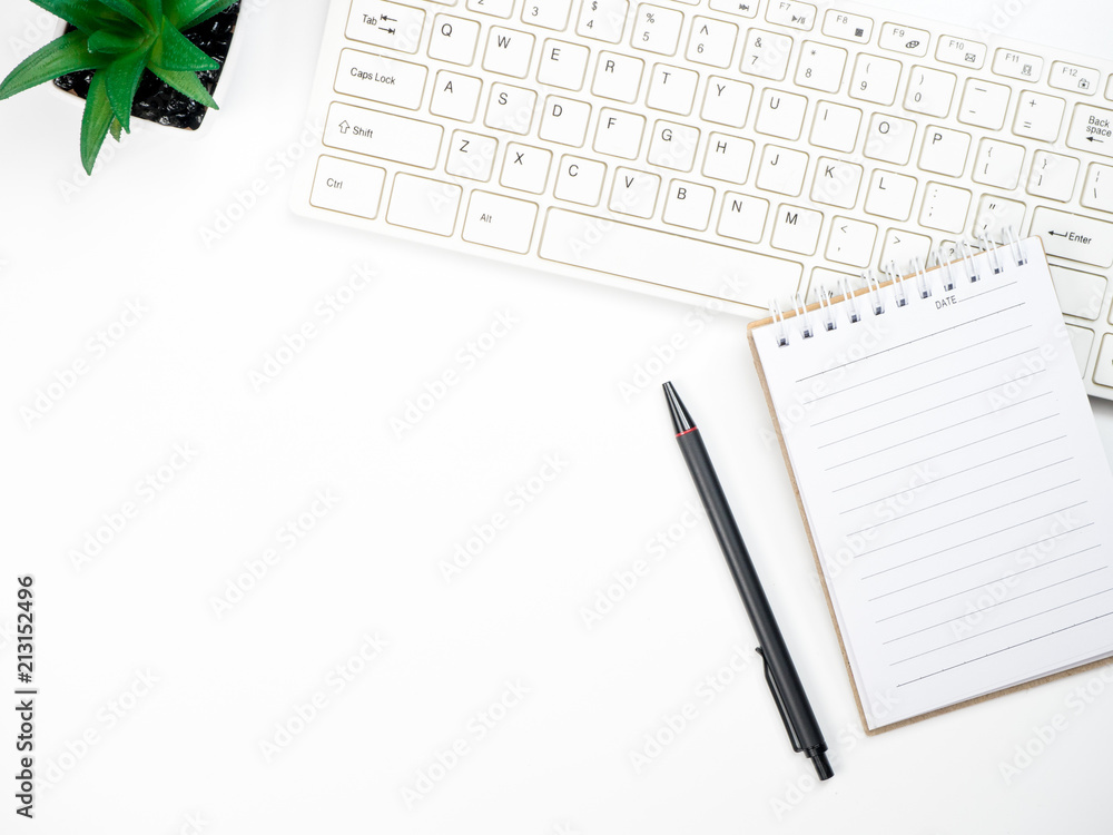Modern white office desk table with keyboard computer and other office supplies of necessity, Top view with copy space Modern white office desk table with keyboard computer and other office supplies of necessity, Top view with copy space