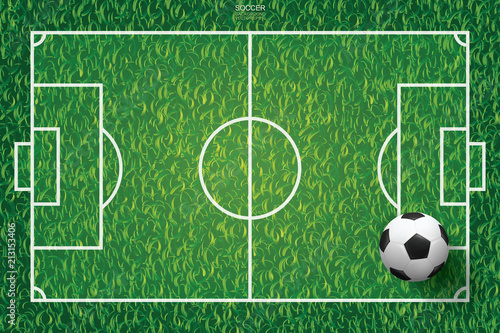 Soccer football ball on green grass of soccer field background. Vector.