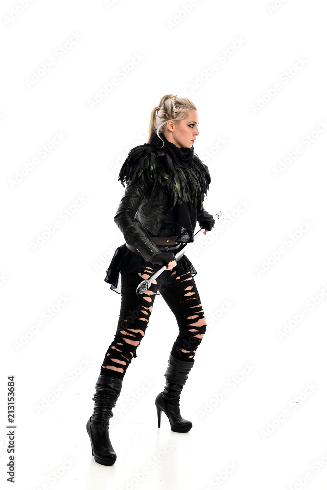 full length portrait of blonde girl wearing black gothic outfit, holding a staff. standing pose, isolated on white studio background. full length portrait of blonde girl wearing black gothic outfit, holding a staff. standing pose, isolated on white studio background.