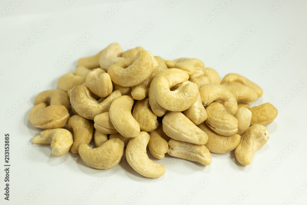 cashew nuts heap , yellow color beans on white background cashew nuts heap , yellow color beans on white background
