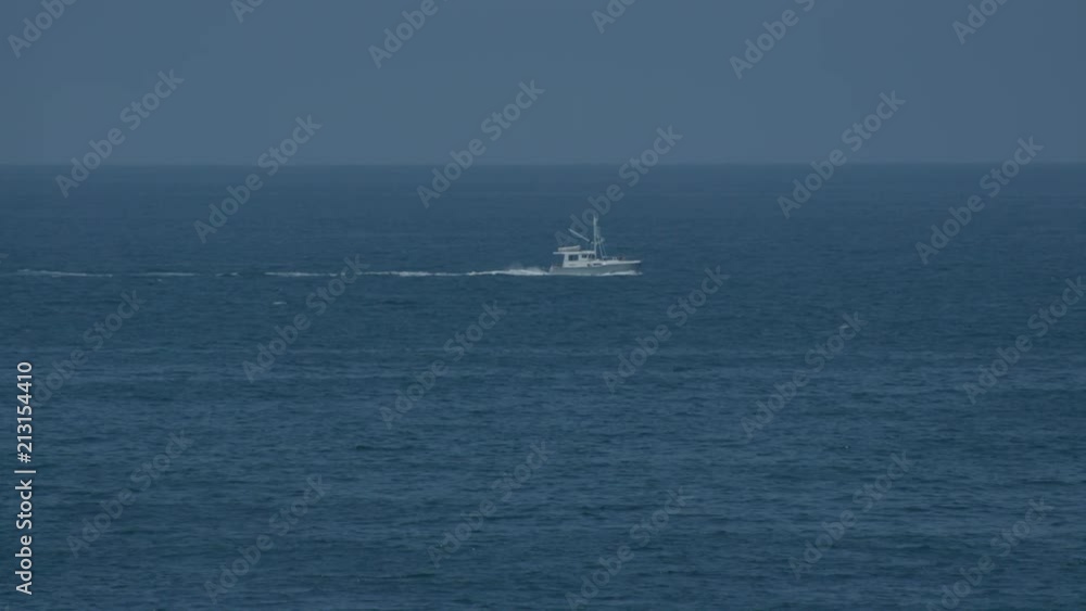 Slow Motion Boat crusing the sea at Torrance beach, during summer morning. Slow Motion Boat crusing the sea at Torrance beach, during summer morning.