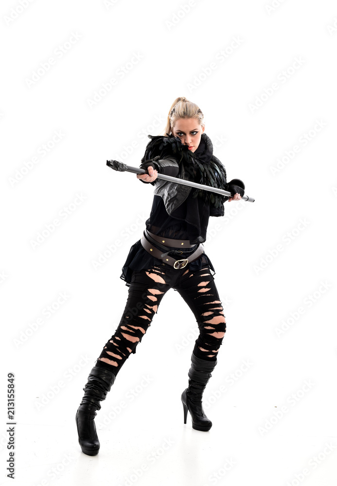 full length portrait of blonde girl wearing black gothic outfit, holding a staff. standing pose, isolated on white studio background. full length portrait of blonde girl wearing black gothic outfit, holding a staff. standing pose, isolated on white studio background.
