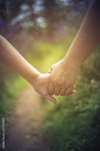 Loving couple holding hands while walking in the park