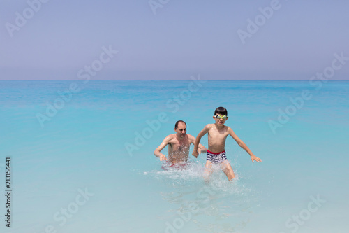 Father and son at Ionian Sea, Egremni beach, Lefkada Greece