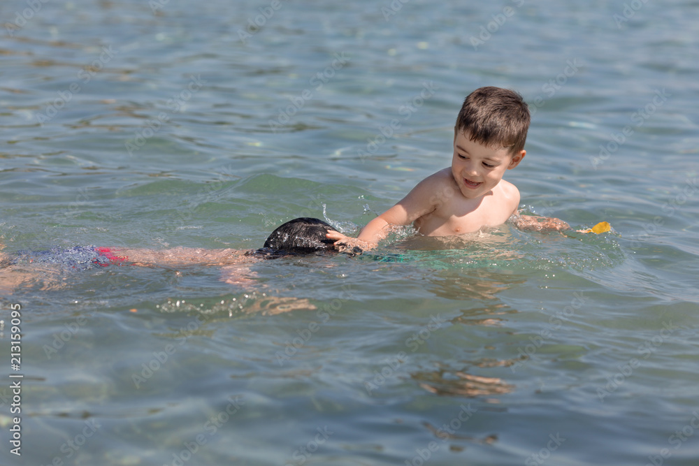 Brothers playing in the sea, Corfu island, Greece