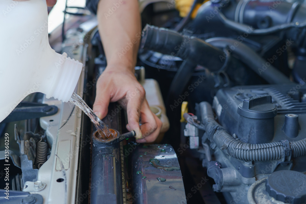 Change the oil, Car mechanic pouring clean water in to engine. Change the oil, Car mechanic pouring clean water in to engine.