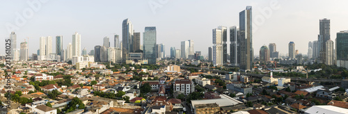 Stunning panorama of Jakarta South Central Business district contrasting with low rise residential middle class housing area in Indonesia capital city in Southeast Asia © jakartatravel