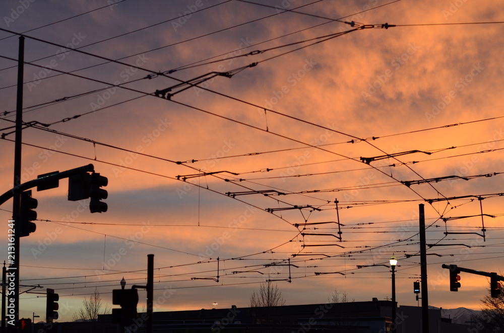 A colorful sky covered in wire and cables for the trains and rails to take the people around the ground. 