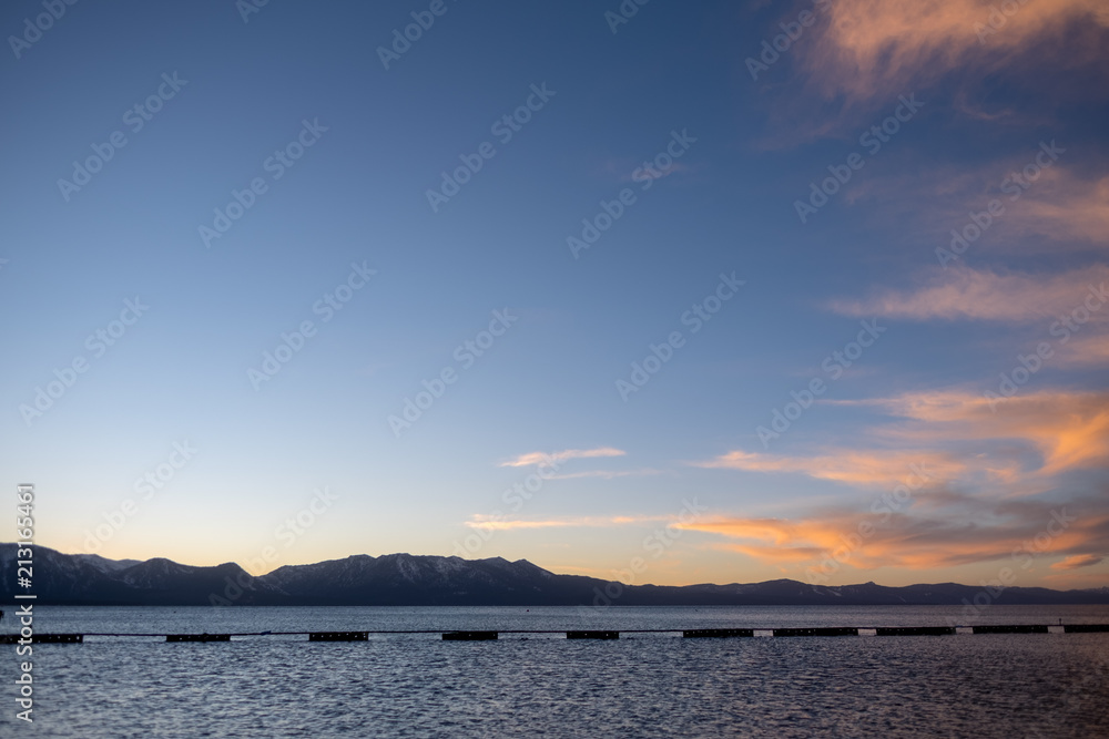 Lake tahoe swimming area - mountains - during sunset - red clouds