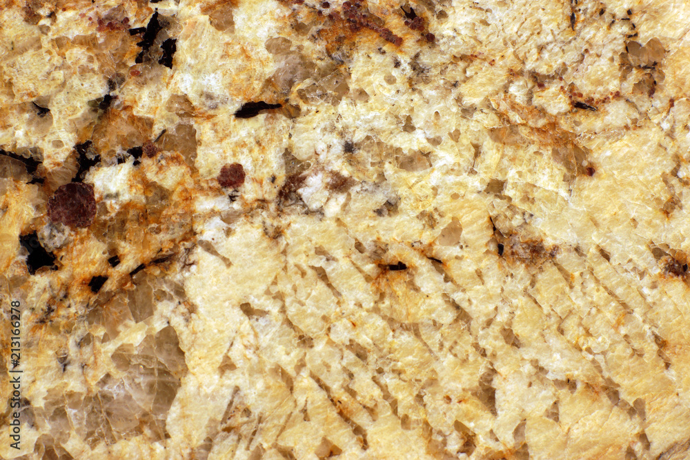 The polished surface of the yellow granite, called Giallo Veneziano The polished surface of the yellow granite, called Giallo Veneziano