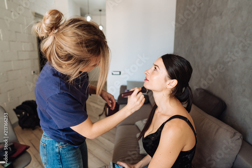 cute, young girl doing makeup