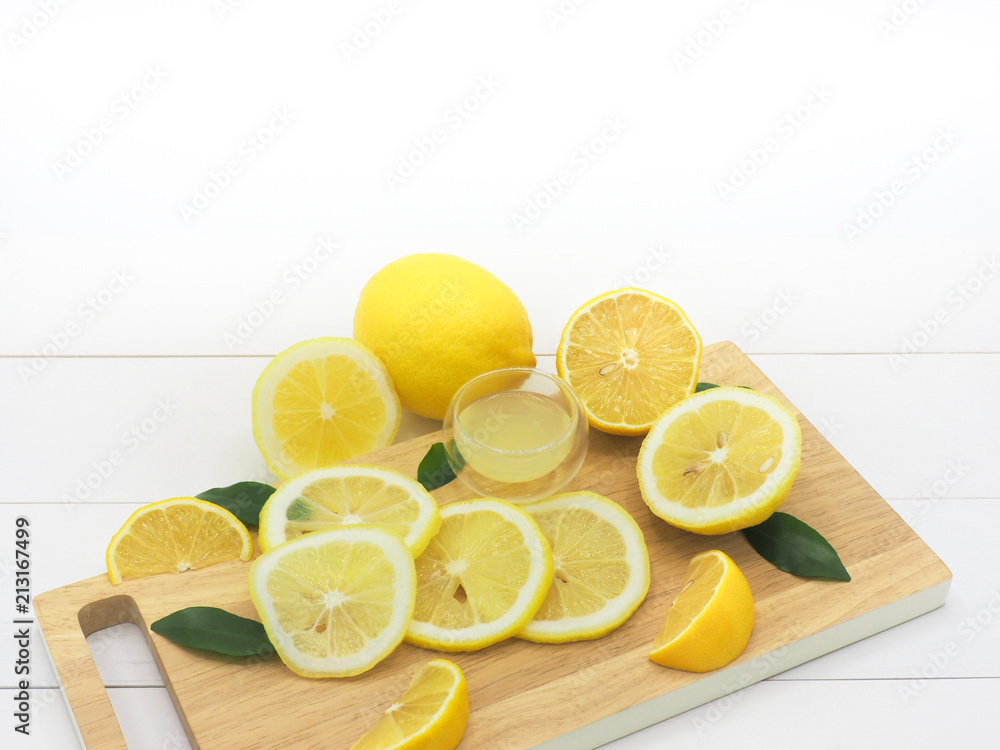 Fresh lemon slice with lemonade on white wood background Fresh lemon slice with lemonade on white wood background