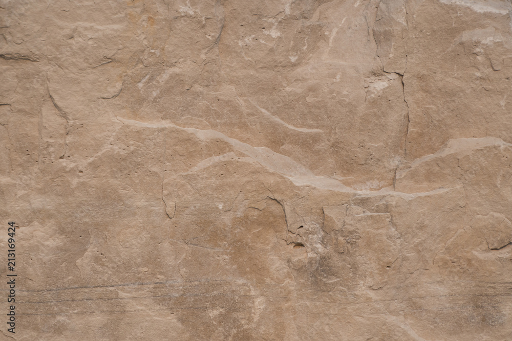 Fototapeta premium Closeup limestone rock face showing weathered strata Geology walpaper or background