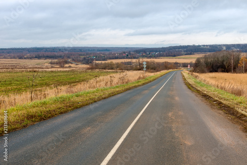 The highway passes through the autumn field