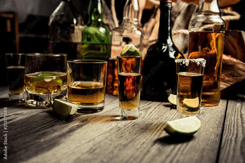 Alcohol in an old bar on a pirate ship with vintage rum and whiskey Alcohol in an old bar on a pirate ship with vintage rum and whiskey