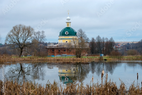 A manor dug pond and a restored church of Michael the Archangel. Manor of Tarakanovo Museum-Reserve DI Mendeleev and AA Blok, Solnechnogorsk district. photo