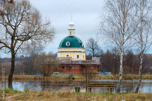 A manor dug pond and a restored church of Michael the Archangel. Manor of Tarakanovo Museum-Reserve DI Mendeleev and AA Blok, Solnechnogorsk district. photo