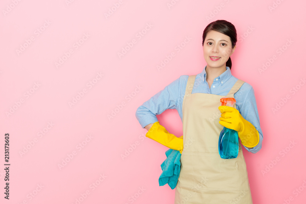 housewife holding a window cleaner bottle