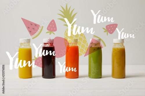 detox smoothies in bottles standing in row, refresh concept, yum yum yum inscription