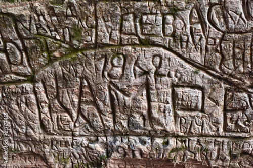 Natural cave in sandstone rock, former bank of Gauja river. Carved wall in Gutmanis cave in Sigulda, Latvia. photo