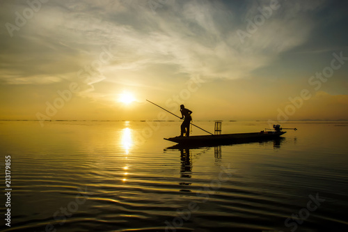 Silhouettes fisherman throwing fishing nets