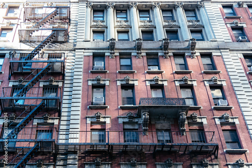 Low angle view of old apartment building with fire escape in New