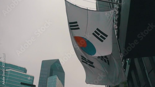 republic of korea flag flying in the wind in the city central of seoul in gangnam photo