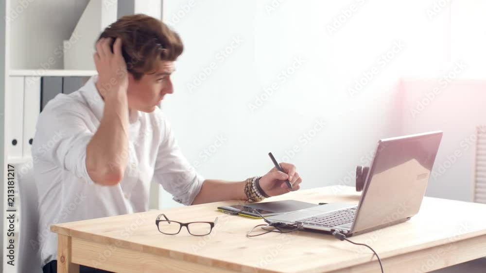 Graphic designer works on the tablet in the office Graphic designer works on the tablet in the office
