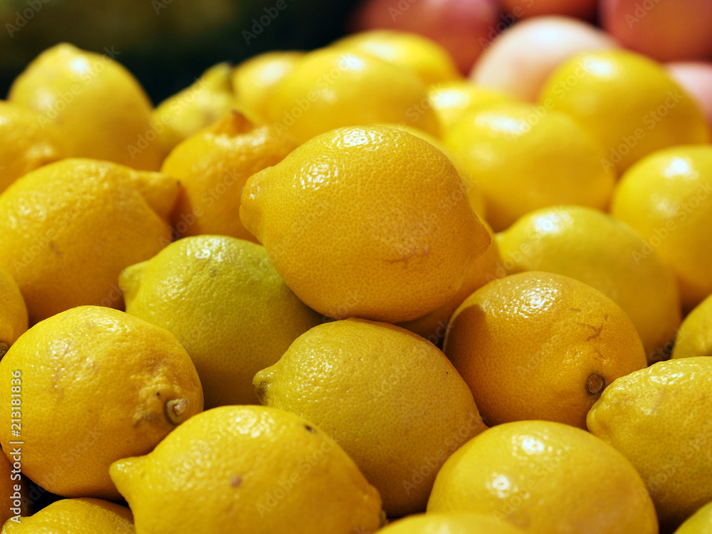 Close up side view of lemons in bulk for sale at supermarket