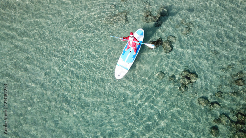 Canvas Print Aerial drone of Santa Claus paddle surfing in Caribbean turquoise clear waters