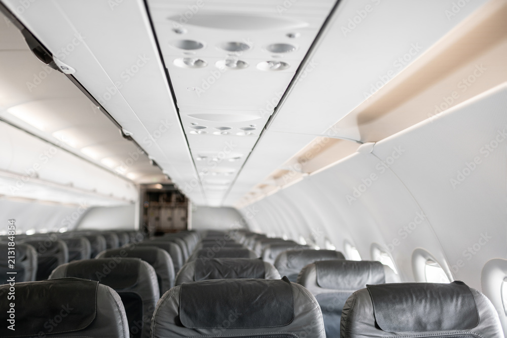 Obraz premium Empty airplane seats in the cabin. Modern Airplane seats in perspective. Transportation concept. Aircraft long-distance international flight