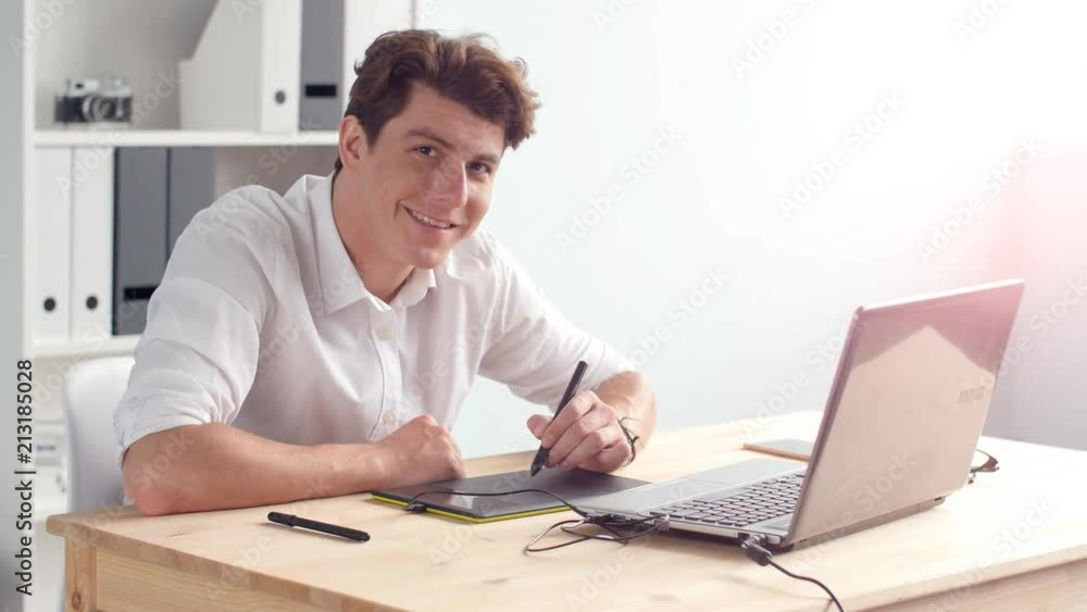 Graphic designer works on the tablet in the office Graphic designer works on the tablet in the office