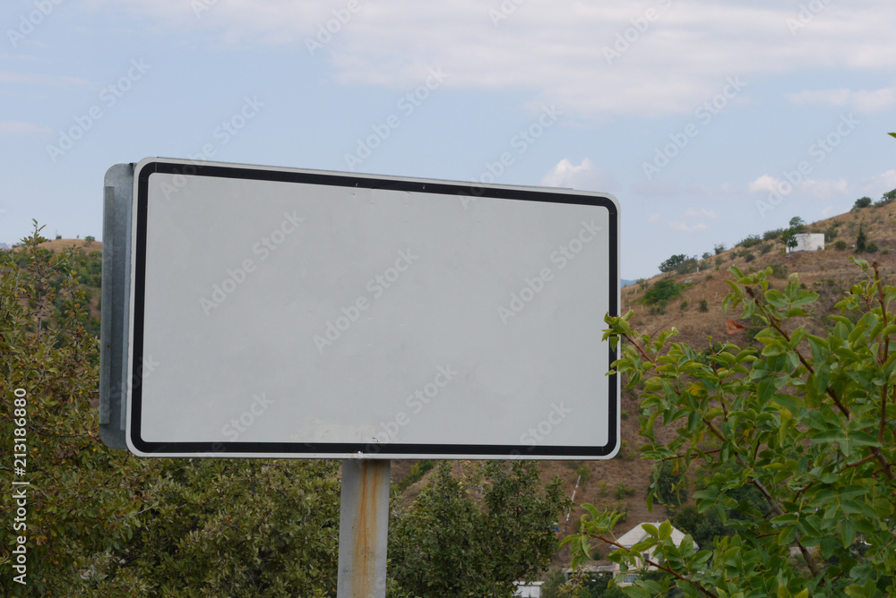 big white billboard on a background of a gentle blue sky