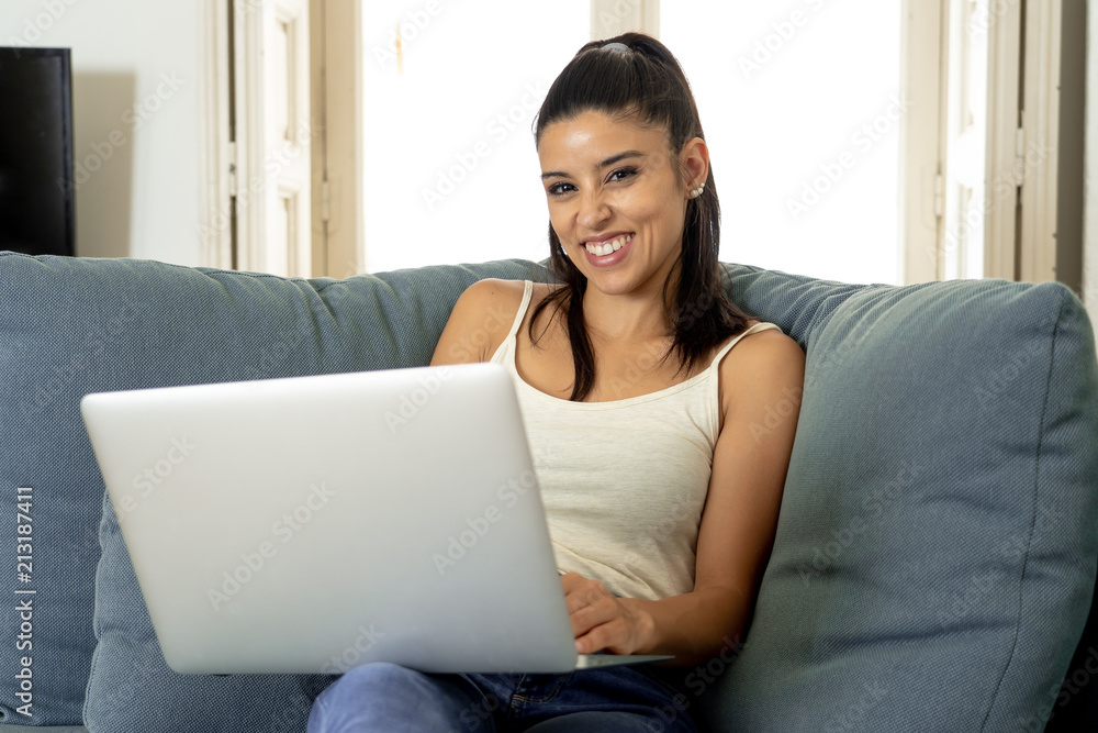 happy pretty latin woman working on laptop at home. happy pretty latin woman working on laptop at home.