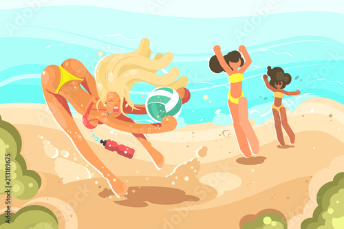 Girls playing volleyball on sand beach