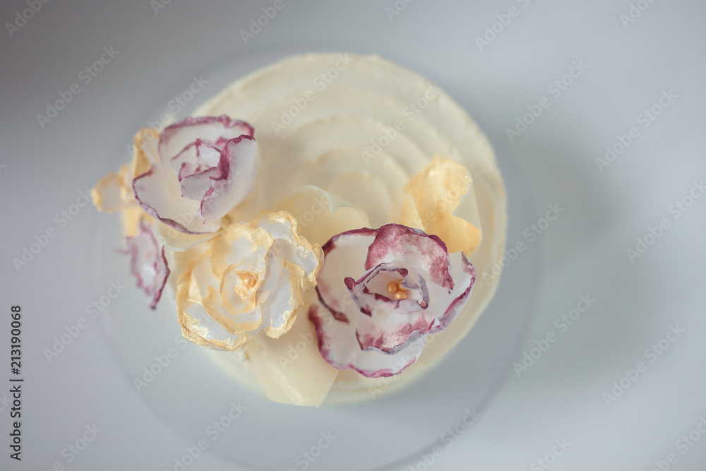 Obraz white cake on a white background with a wafer flowers