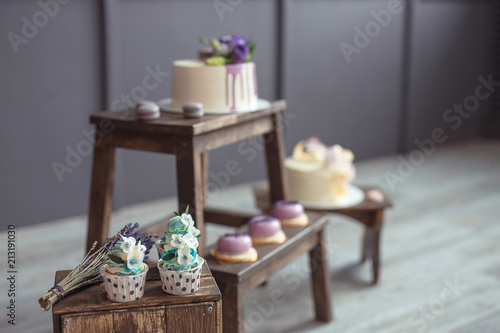 cakes and macaroons on wooden chair on a dark background photo