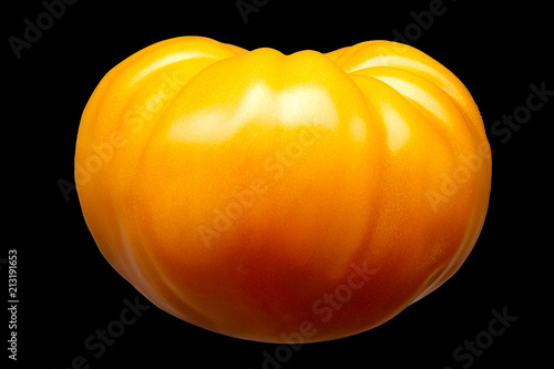 Big delicious single yellow tomato isolated on black background with clipping path