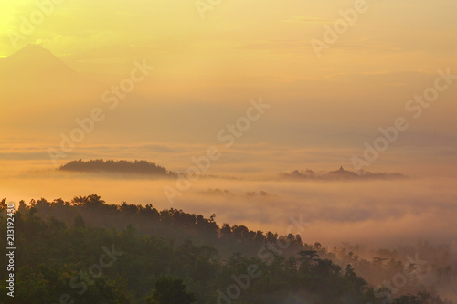 Fototapeta Naklejka Na Ścianę i Meble -  Borobudur Temple in a beautiful foggy sunrise seen from Punthuk Setumbu Hill