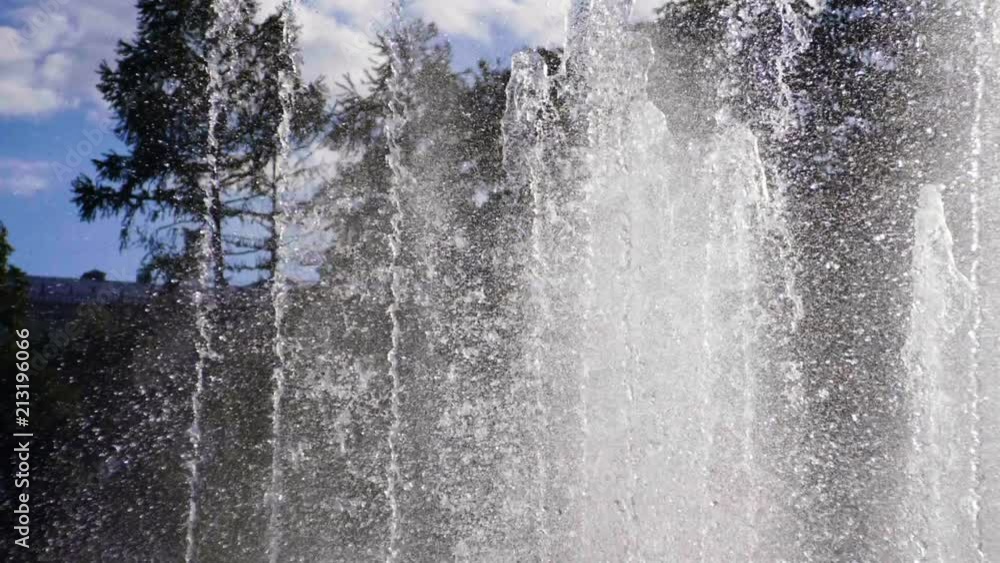 Close-up shot of water drops of fountain in the summer park. Slow motion. HD