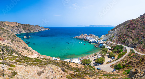 Scenic Firopotamos village (traditional Greek village by the sea, the Cycladic-style) with sirmata - traditional fishermen's houses, Milos island, Cyclades, Greece. © gatsi