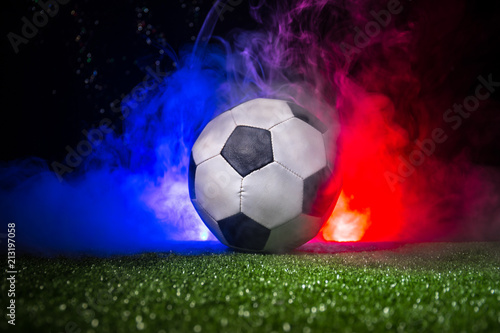 Soccer ball on grass with France flag with smoke and lights. Soccer concept. photo