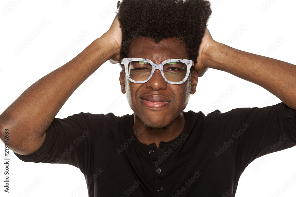 Portrait of young african american man with headache on white background Portrait of young african american man with headache on white background